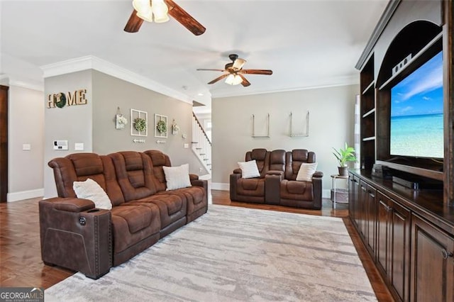 living room with ceiling fan, ornamental molding, and hardwood / wood-style floors