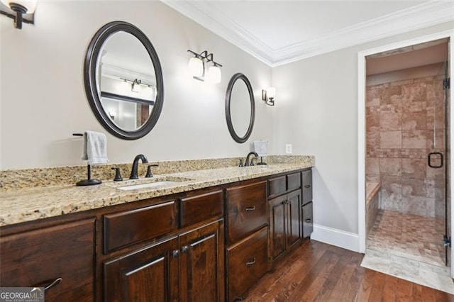 bathroom featuring vanity, crown molding, a shower with shower door, and hardwood / wood-style flooring