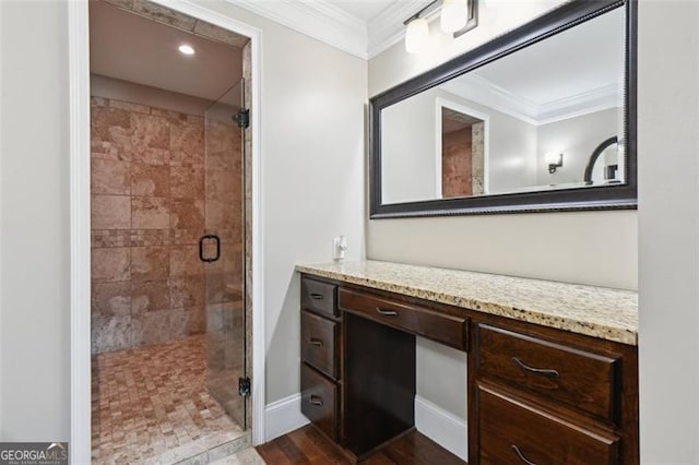 bathroom featuring crown molding, vanity, a shower with door, and wood-type flooring