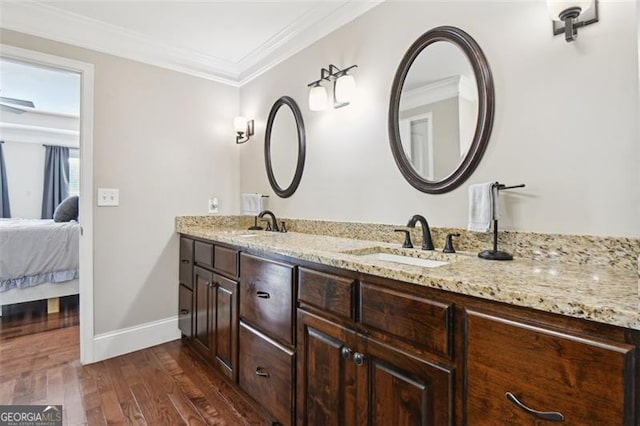 bathroom featuring vanity, hardwood / wood-style flooring, and ornamental molding