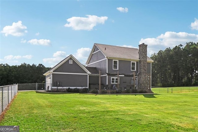 rear view of property featuring a lawn