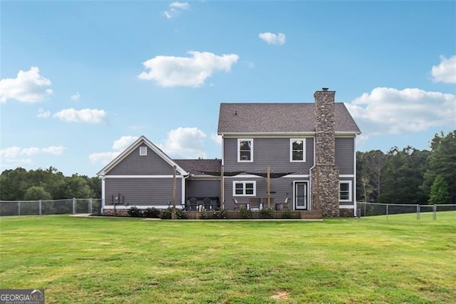 rear view of property with a yard