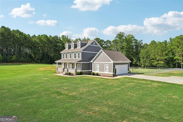 view of front of home with a garage, a front yard, and covered porch