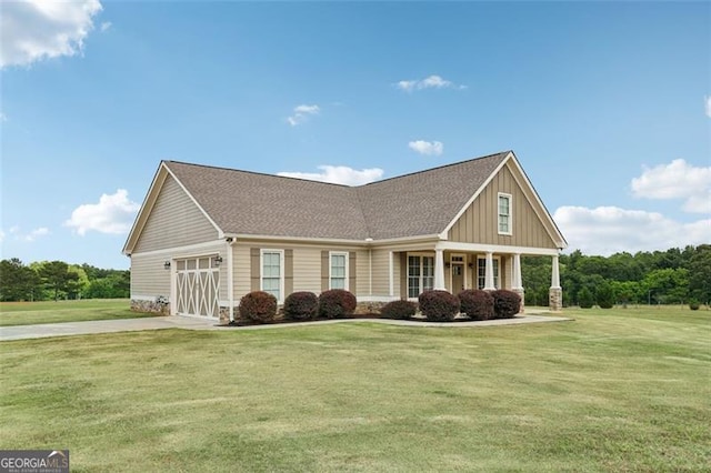 craftsman house with covered porch and a front yard