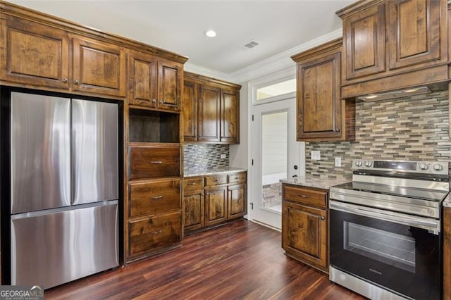 kitchen featuring appliances with stainless steel finishes, dark hardwood / wood-style floors, decorative backsplash, light stone counters, and crown molding