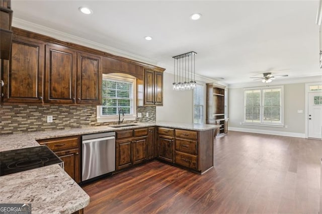 kitchen featuring sink, stainless steel dishwasher, ornamental molding, kitchen peninsula, and pendant lighting