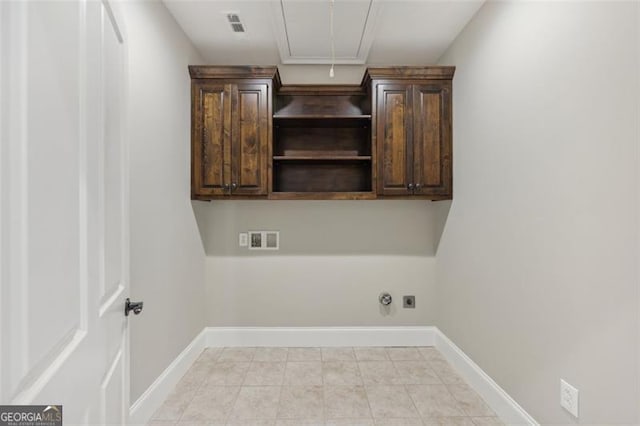 clothes washing area with cabinets, electric dryer hookup, washer hookup, and hookup for a gas dryer