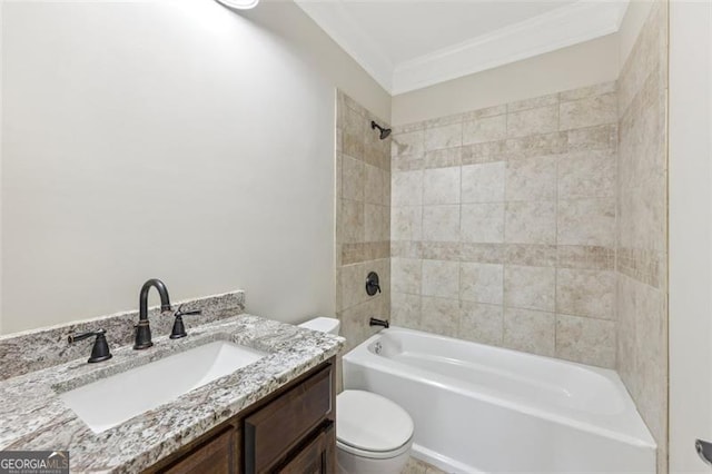 full bathroom featuring vanity, ornamental molding, toilet, and tiled shower / bath