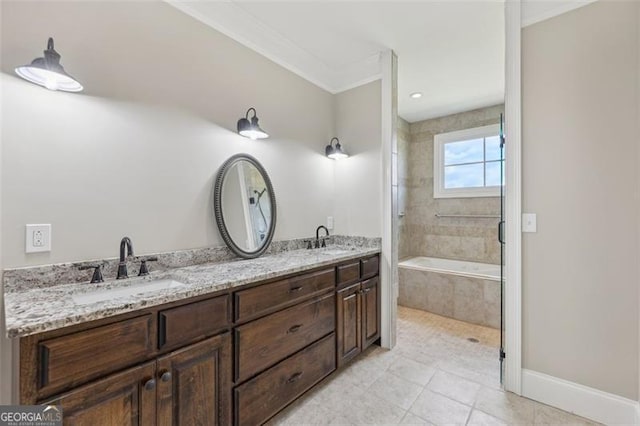 bathroom with vanity, tile patterned floors, ornamental molding, and tiled bath