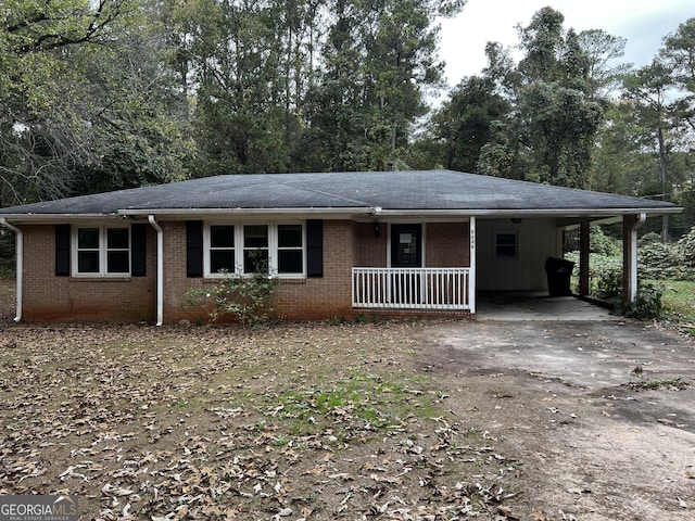 single story home with covered porch and a carport