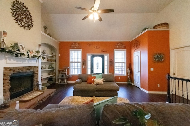 living room featuring a fireplace, built in features, dark hardwood / wood-style flooring, and vaulted ceiling