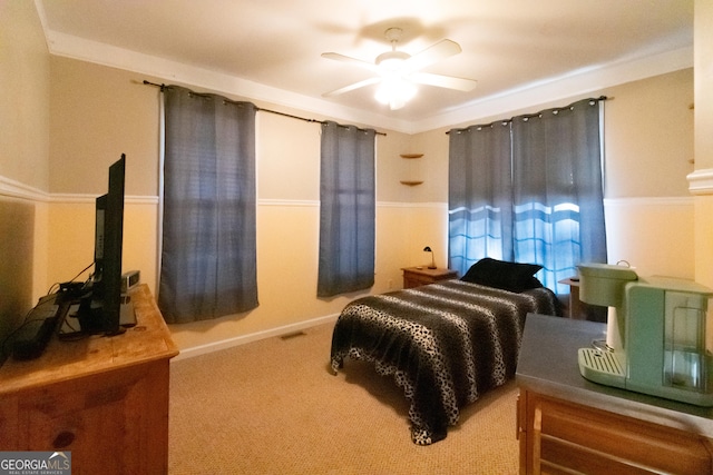 carpeted bedroom with crown molding and ceiling fan