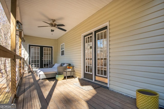 deck featuring an outdoor living space and ceiling fan