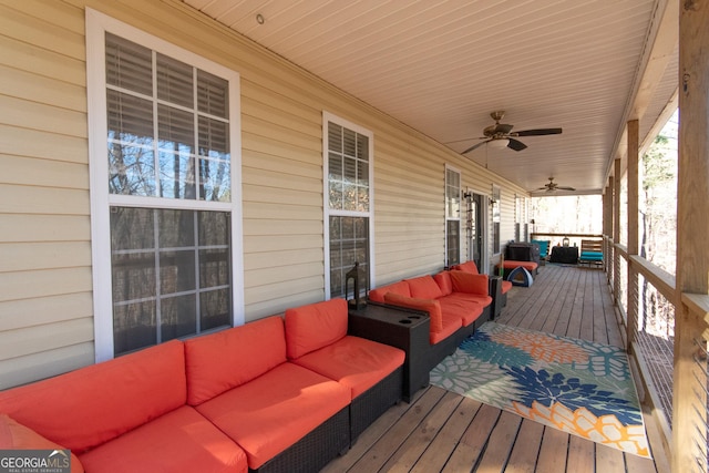 wooden terrace featuring a porch, an outdoor hangout area, and ceiling fan