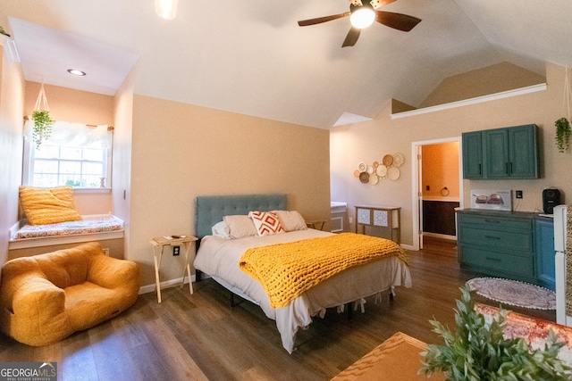 bedroom with ceiling fan, ensuite bathroom, vaulted ceiling, and dark wood-type flooring