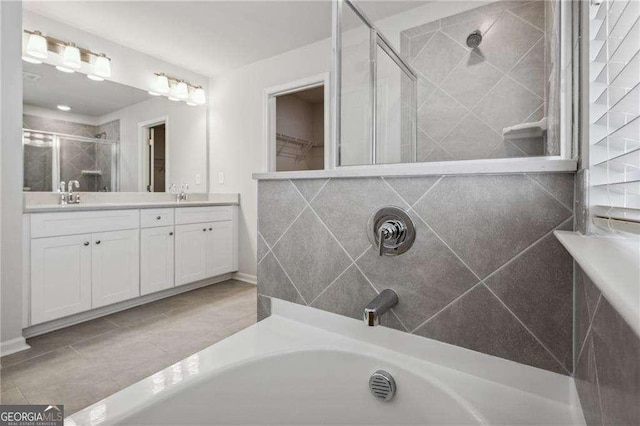 bathroom with vanity and independent shower and bath