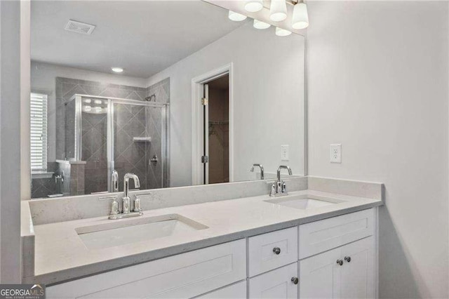 bathroom featuring walk in shower and vanity