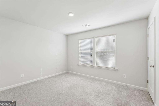 empty room featuring light colored carpet