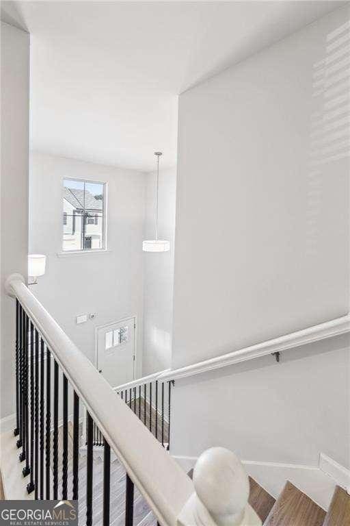 stairway featuring wood-type flooring