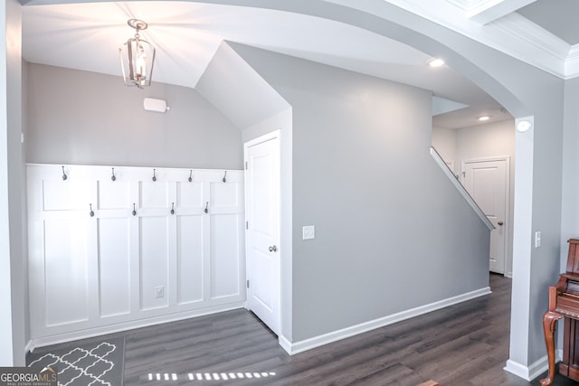 interior space with crown molding and dark wood-type flooring