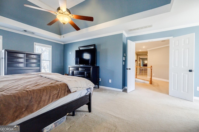 bedroom featuring ceiling fan, carpet floors, a tray ceiling, and crown molding