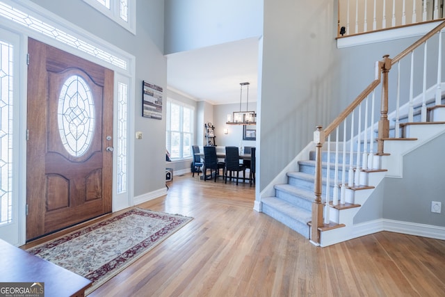 foyer featuring light hardwood / wood-style flooring and a chandelier