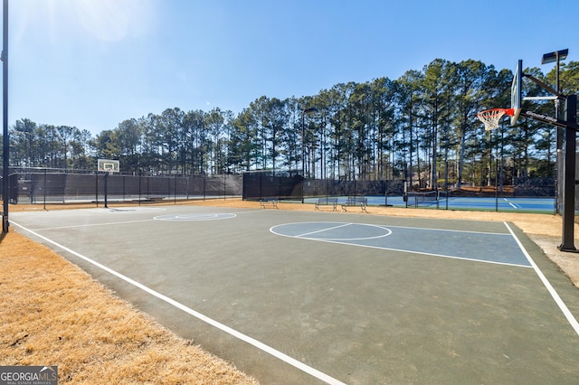 view of sport court featuring tennis court