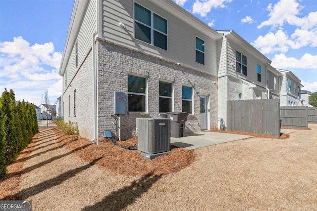 back of property with a patio area and cooling unit