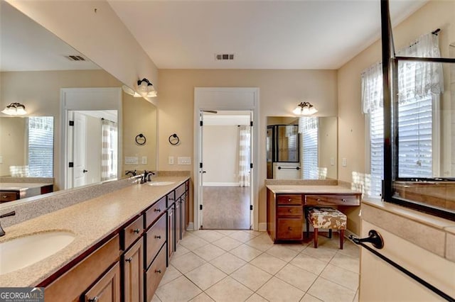 bathroom with tile patterned flooring, visible vents, and a sink