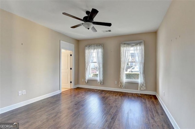 unfurnished room with baseboards, visible vents, ceiling fan, and wood finished floors