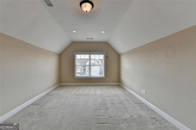 bonus room with vaulted ceiling, carpet floors, visible vents, and baseboards