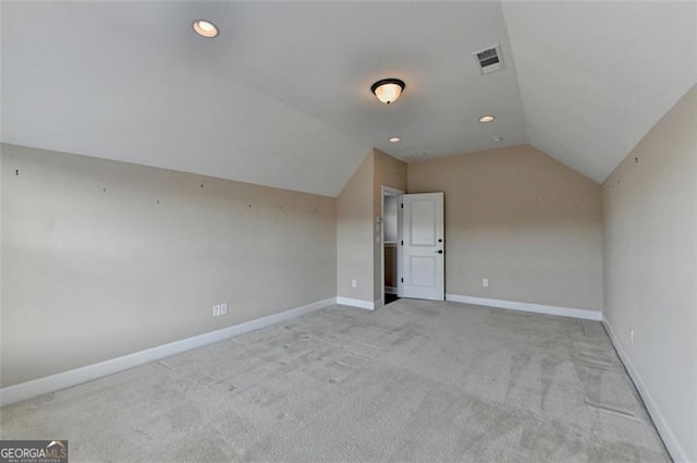 bonus room featuring recessed lighting, light colored carpet, visible vents, baseboards, and vaulted ceiling