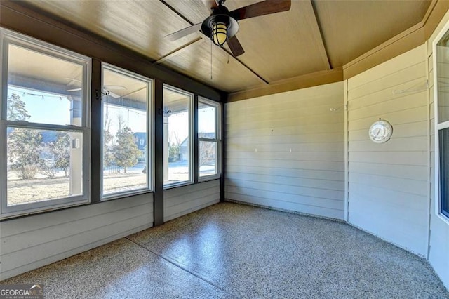 unfurnished sunroom featuring a ceiling fan