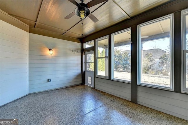 unfurnished sunroom with a ceiling fan