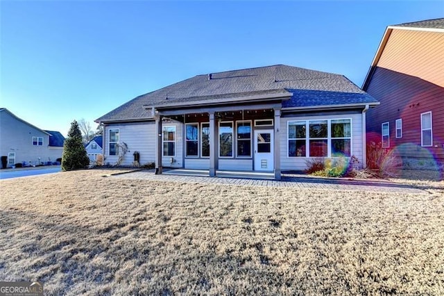 back of property with roof with shingles