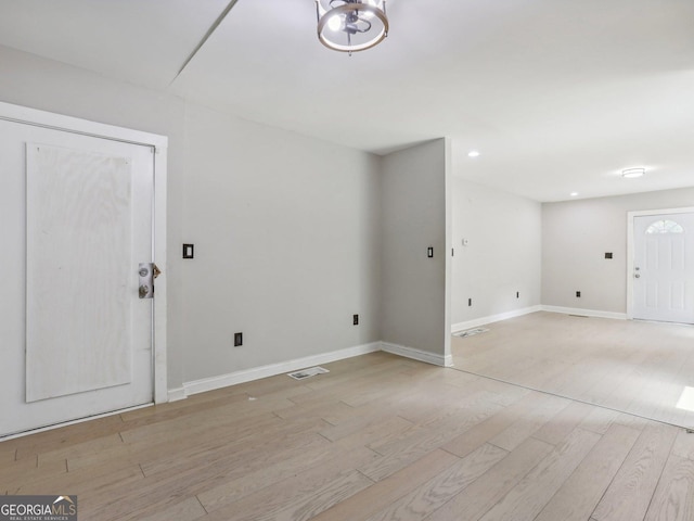 interior space with baseboards, visible vents, light wood-style floors, and recessed lighting