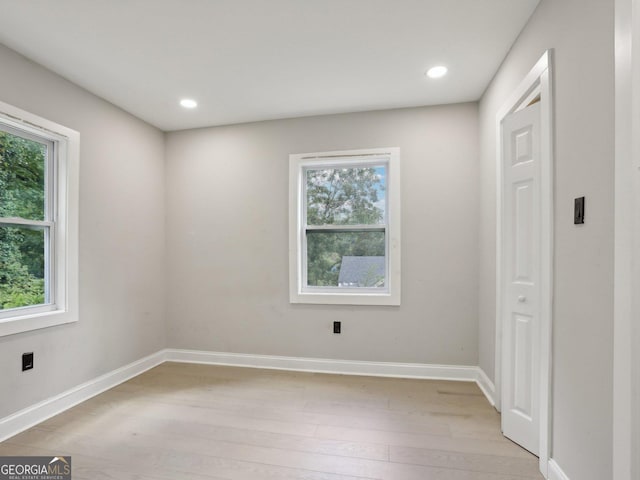 unfurnished room with recessed lighting, baseboards, and light wood-type flooring