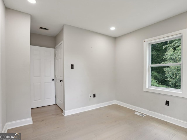 empty room featuring recessed lighting, visible vents, baseboards, and light wood-type flooring