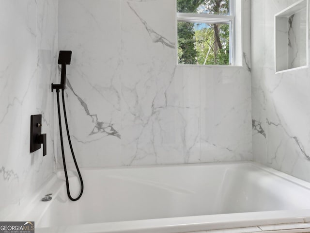 full bath featuring a marble finish shower and a bath