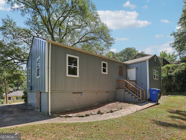 view of front of property featuring a front lawn and board and batten siding