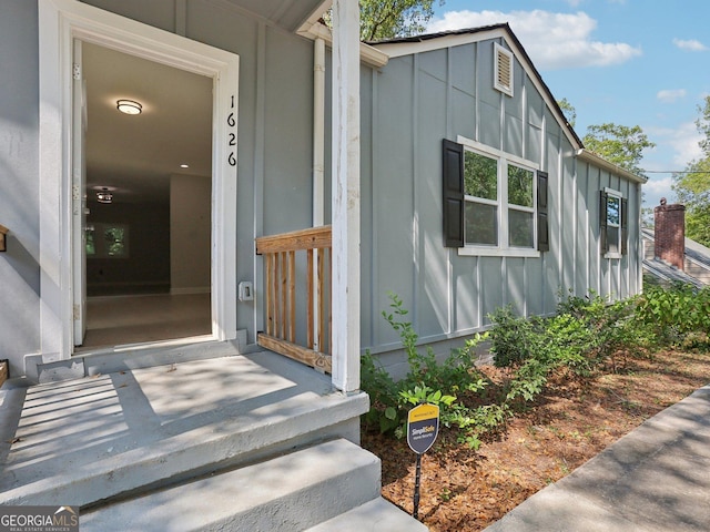 view of exterior entry featuring board and batten siding