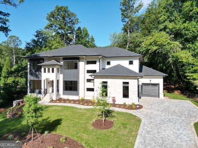 view of front of home with a garage and a front lawn