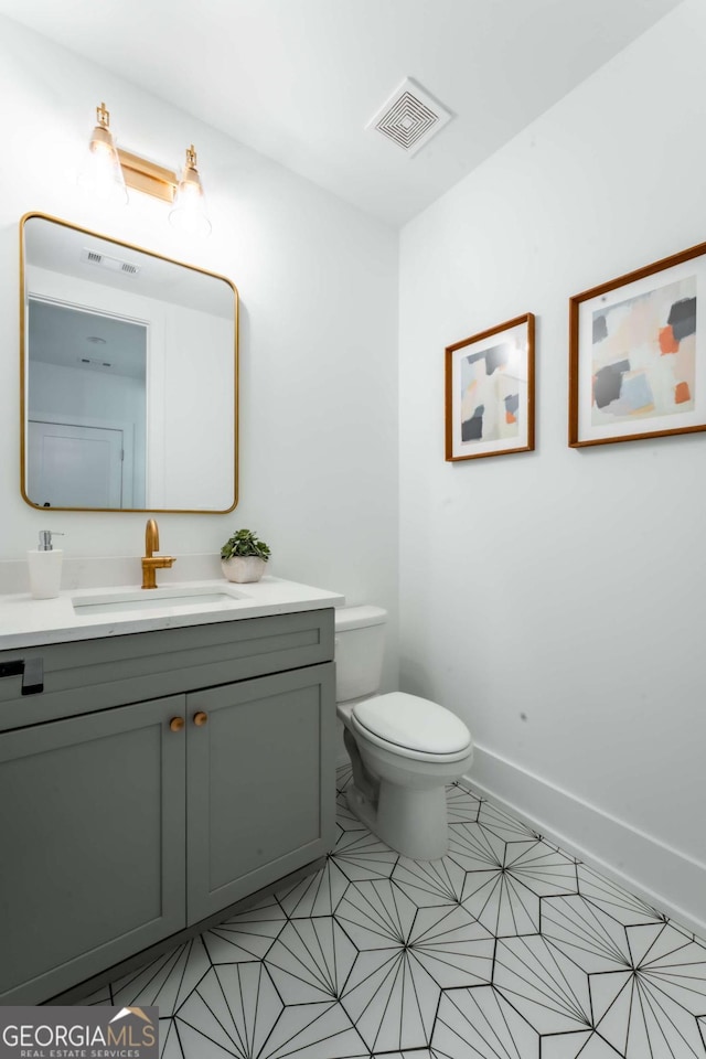 bathroom with toilet and vanity