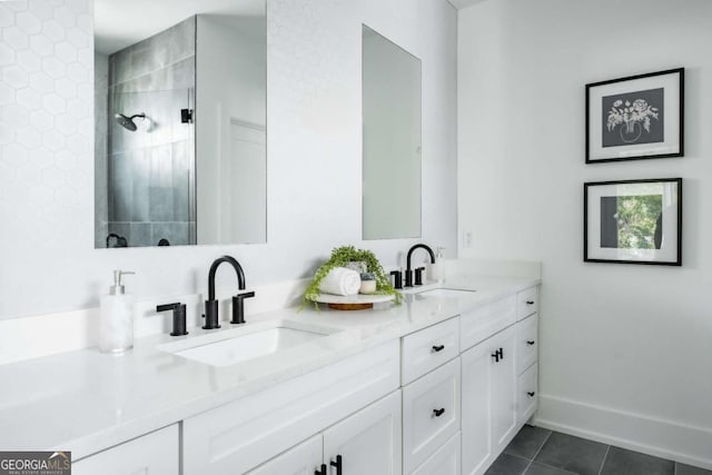 bathroom with tile patterned floors, vanity, and a tile shower