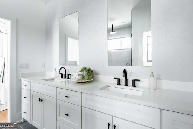 bathroom featuring walk in shower and vanity