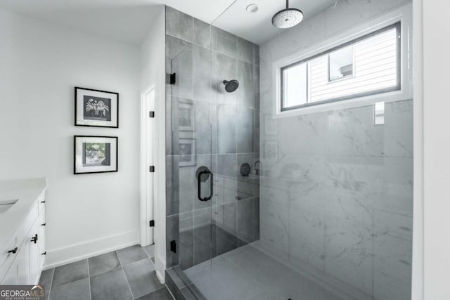 bathroom featuring vanity, walk in shower, and tile patterned floors