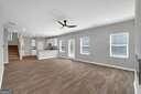 unfurnished living room with ceiling fan