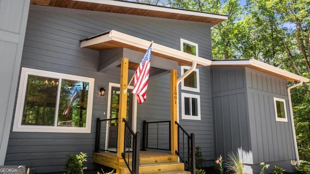 property entrance featuring board and batten siding