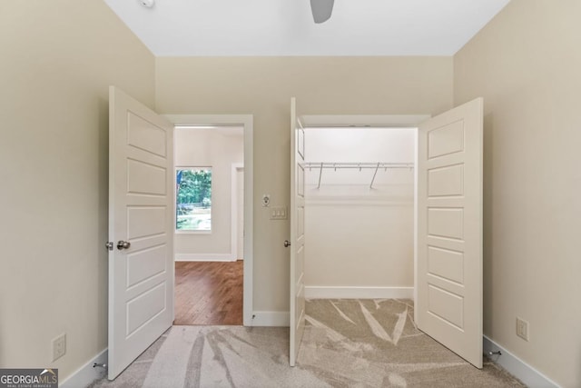 interior space with a closet, carpet flooring, a ceiling fan, and baseboards