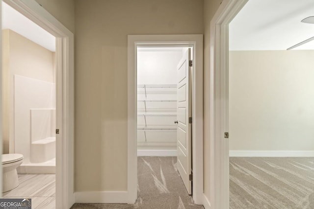 interior space with baseboards and carpet flooring